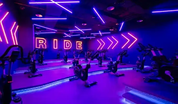 Gym spinning room equipped with stationary bikes for cycling workouts and fitness classes.